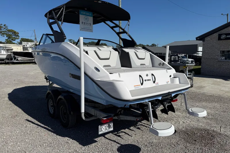 Slide: The Image of 2024 Yamaha Boats AR220 for sale, displayed on a trailer in a boat dealership. - 4