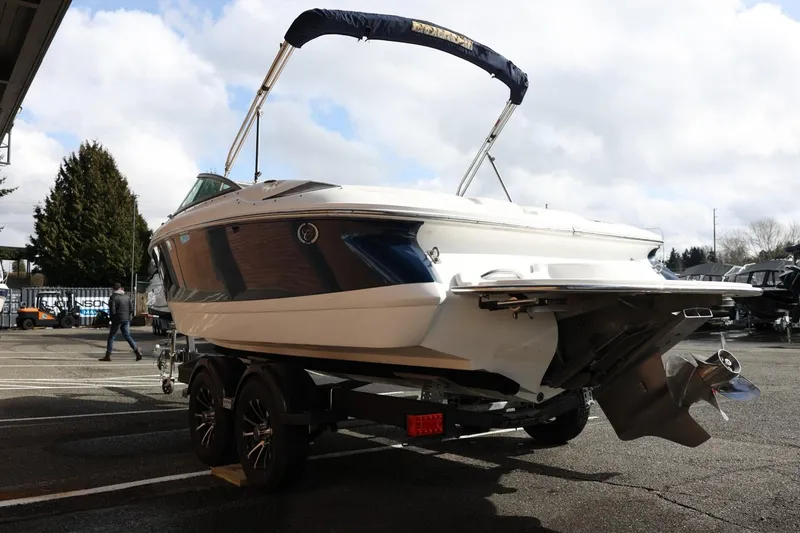 Slide: The Image of 2005 Cobalt 200 boat on trailer, parked outdoors under cloudy sky. - 10