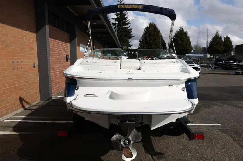 Slide: The Image of 2005 Cobalt 200 boat, rear view, parked outdoors near brick building. - 11