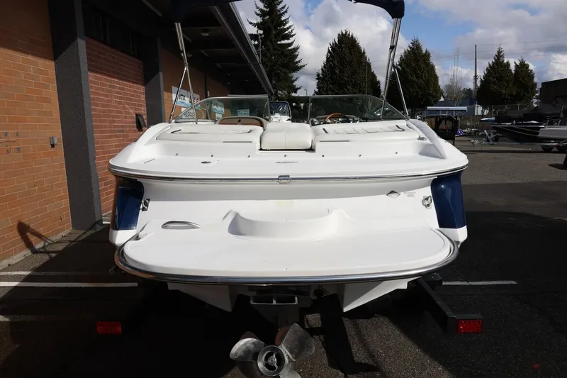 Slide: The Image of Rear view of a 2005 Cobalt 200 boat, parked outdoors on a sunny day. - 15