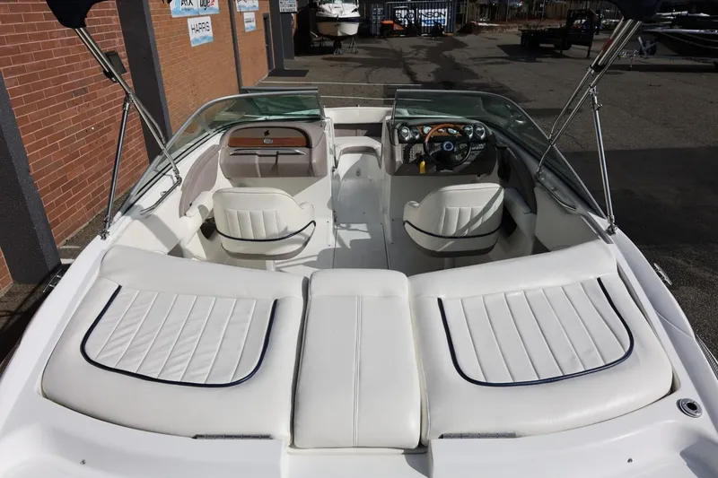 Slide: The Image of Interior view of a 2005 Cobalt 200 boat with white seating and dashboard. - 16