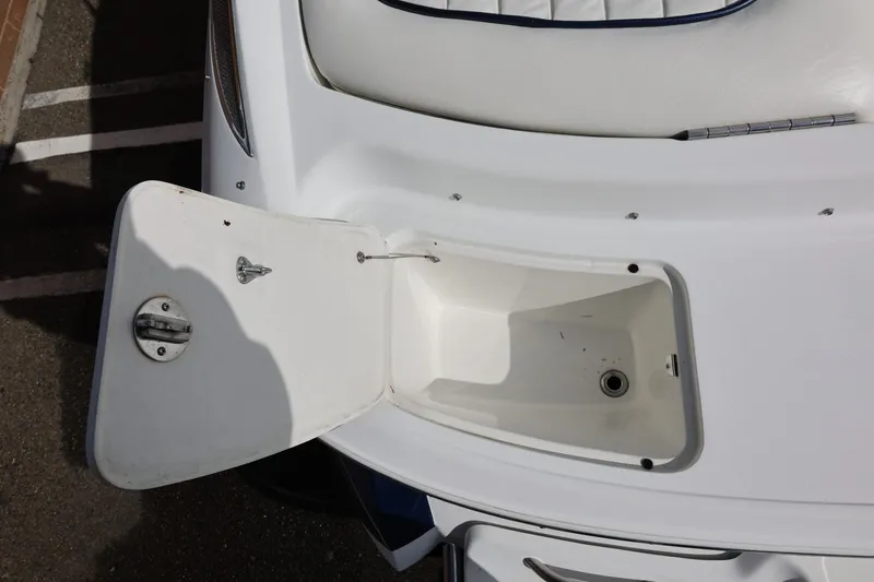 Slide: The Image of Open storage compartment on a 2005 Cobalt 200 boat, showing interior details. - 19