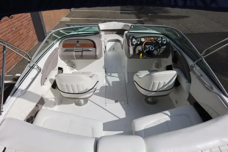 Slide: The Image of 2005 Cobalt 200 boat interior with white seating and sleek dashboard design. - 20