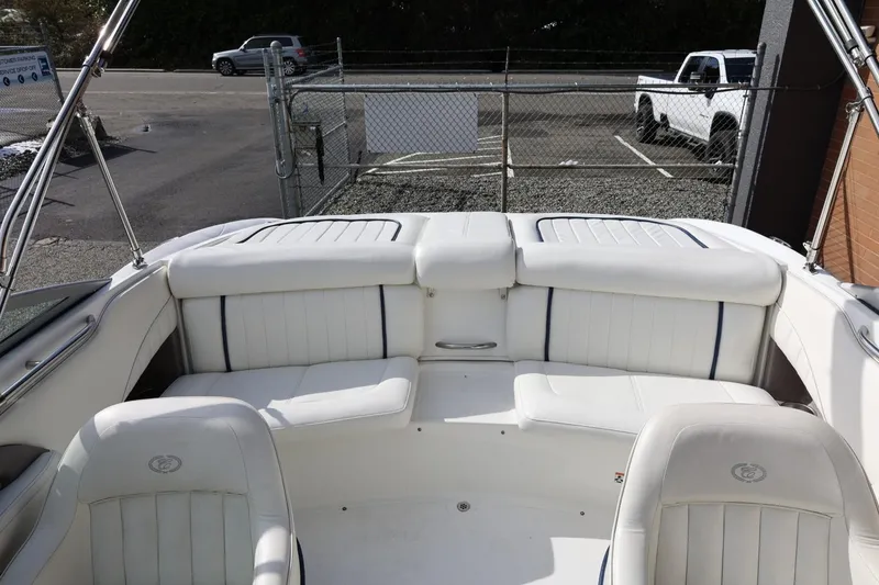 Slide: The Image of Interior of a 2005 Cobalt 200 boat with white seating and open deck. - 21
