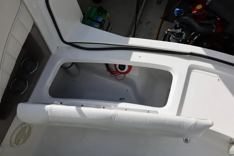 Slide: The Image of Interior view of a 2005 Cobalt 200 boat, showcasing storage compartment and engine area. - 23