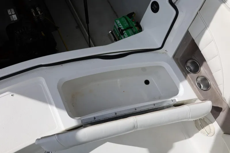 Slide: The Image of Interior view of a 2005 Cobalt 200 boat showing storage compartment and cup holders. - 24