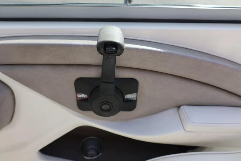 Slide: The Image of Manual window crank in a 2005 Cobalt 200 car interior. - 27