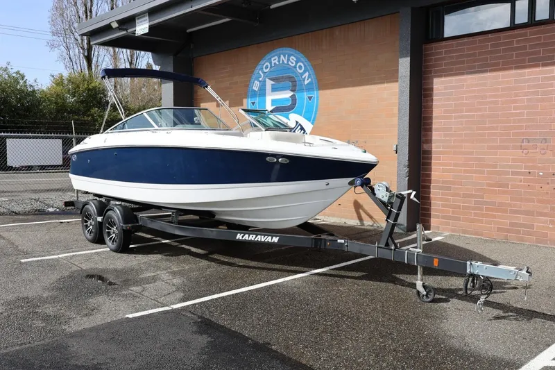 Slide: The Image of 2005 Cobalt 200 boat on Karavan trailer, parked outdoors near brick building. - 3