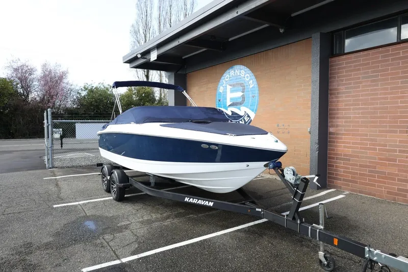 Slide: The Image of 2005 Cobalt 200 boat on Karavan trailer, parked outside a brick building. - 30