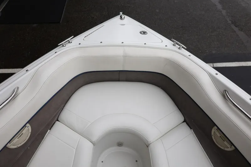 Slide: The Image of Bow seating area of a 2005 Cobalt 200 boat with white upholstery. - 32