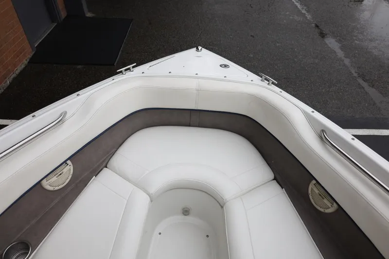 Slide: The Image of Interior of a 2005 Cobalt 200 boat with white cushioned seating. - 36