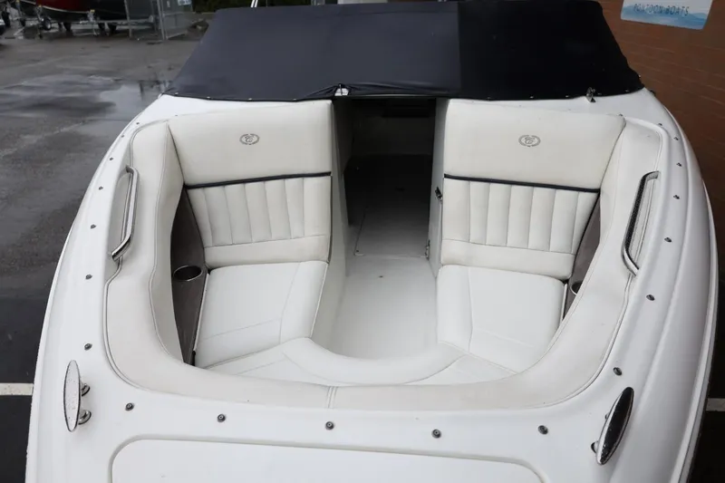 Slide: The Image of 2005 Cobalt 200 boat interior with white cushioned seating and sleek design. - 37