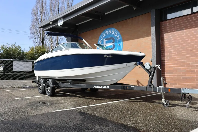 Slide: The Image of 2005 Cobalt 200 boat on Karavan trailer, parked outdoors near brick building. - 4