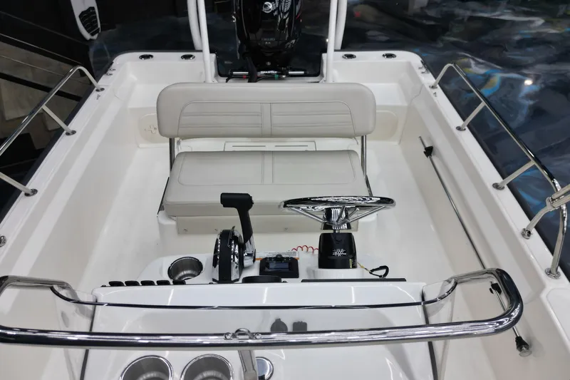 Slide: The Image of 2025 Boston Whaler 170 Montauk boat interior with steering wheel and seating. - 10