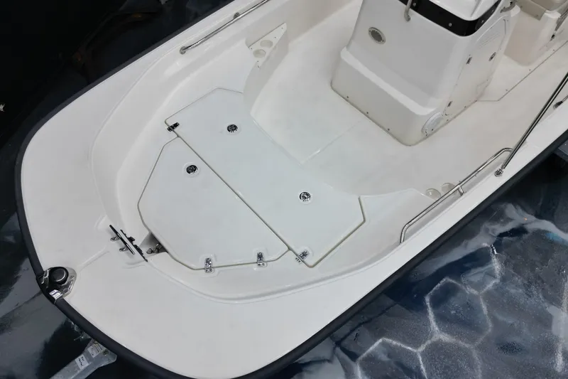 Slide: The Image of 2025 Boston Whaler 170 Montauk boat interior, featuring sleek white deck design. - 11