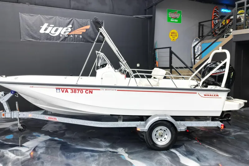 Slide: The Image of 2025 Boston Whaler 170 Montauk boat on trailer in showroom setting. - 16