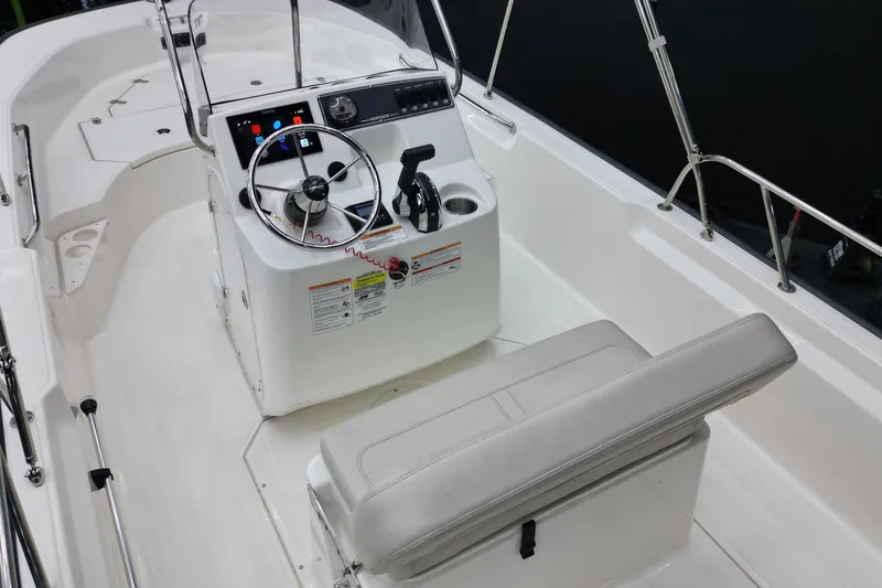 Slide: The Image of 2025 Boston Whaler 170 Montauk boat interior with steering console and seating. - 6