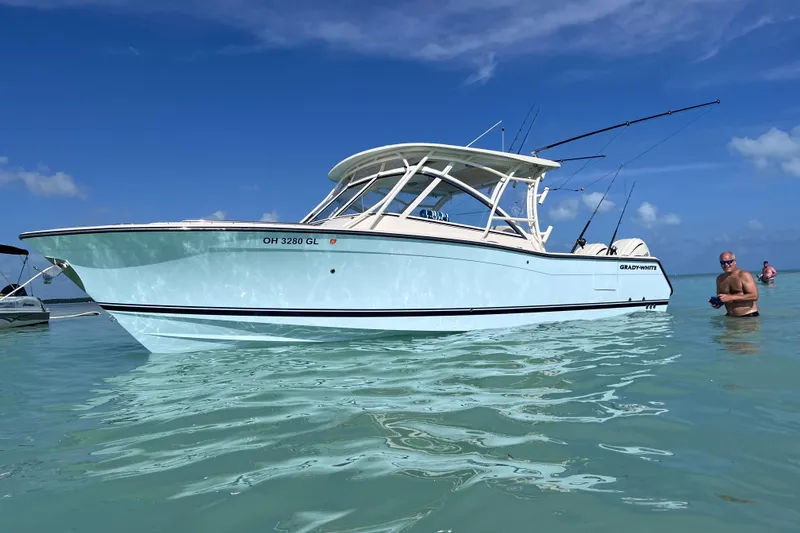 Slide: The Image of 2024 Grady-White Freedom 307 boat on clear blue water, sunny day. - 12