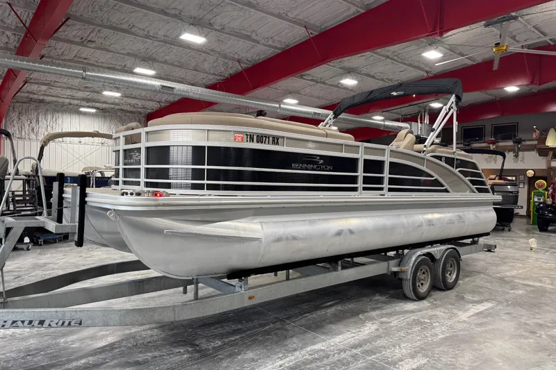 The Image of 2019 Bennington R23 pontoon boat on trailer in indoor storage facility. - 1