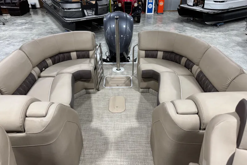 Slide: The Image of 2019 Bennington R23 boat interior with beige seating and carpeted floor. - 12