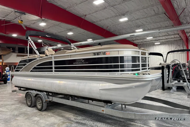Slide: The Image of 2019 Bennington R23 pontoon boat on trailer in indoor showroom. - 2