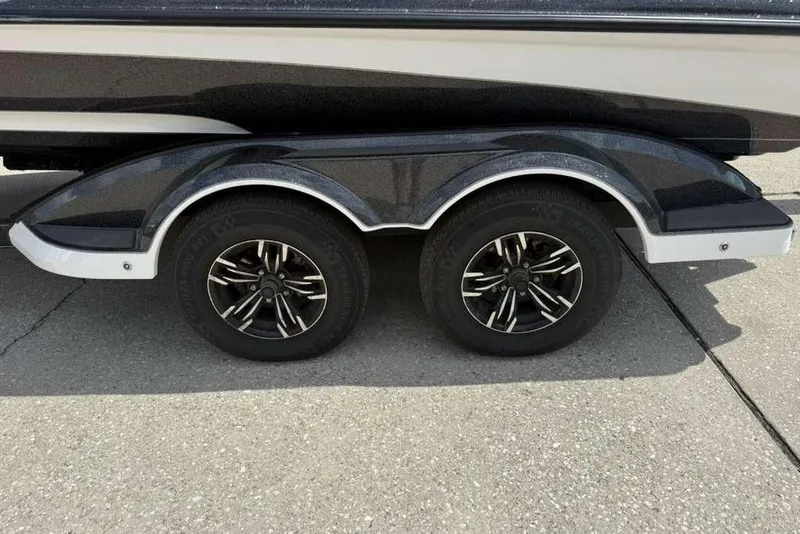 Slide: The Image of 2025 Caymas CX 20 PRO trailer with dual black alloy wheels on concrete surface. - 15