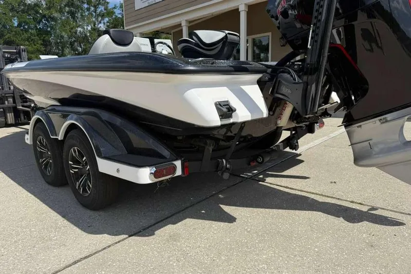 Slide: The Image of 2025 Caymas CX 20 PRO boat on trailer, showcasing sleek design and dual axle wheels. - 17