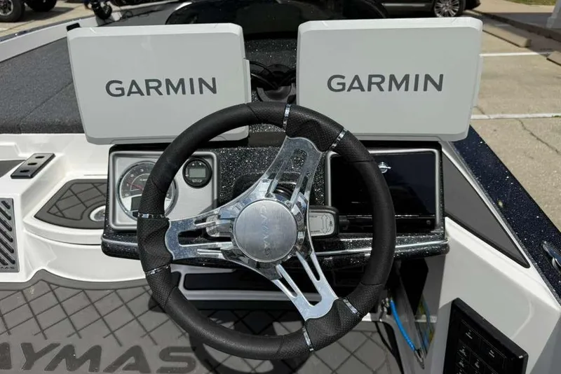 Slide: The Image of 2025 Caymas CX 20 PRO boat dashboard with dual Garmin displays and steering wheel. - 23