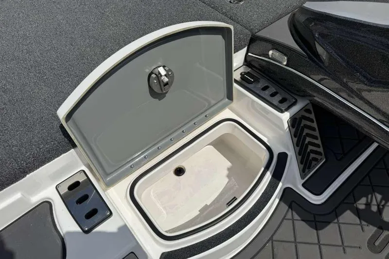 Slide: The Image of 2025 Caymas CX 20 PRO boat storage compartment with open lid, showcasing interior design. - 29