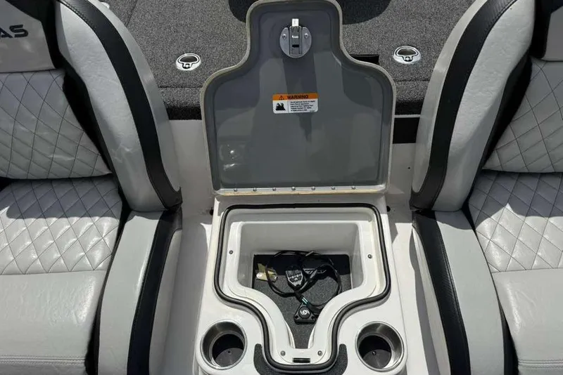 Slide: The Image of 2025 Caymas CX 20 PRO boat interior with open storage compartment and cup holders. - 33