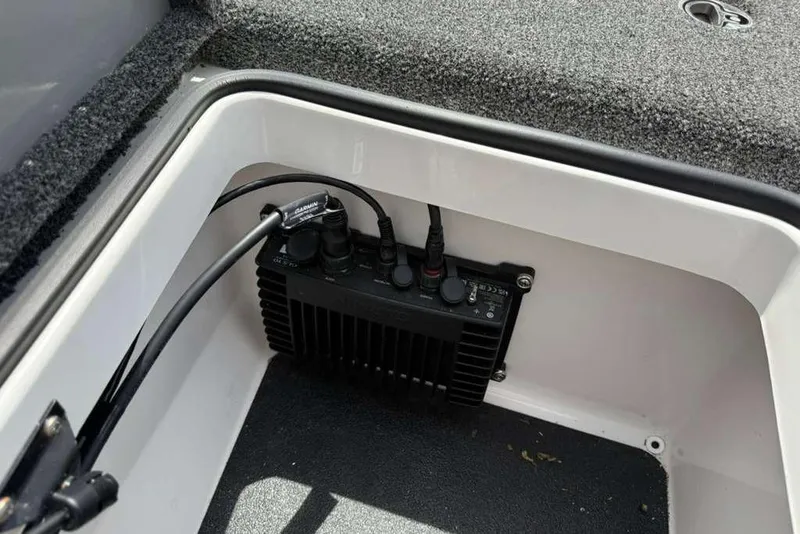 Slide: The Image of 2025 Caymas CX 20 PRO boat compartment with electronic device and cables. - 35