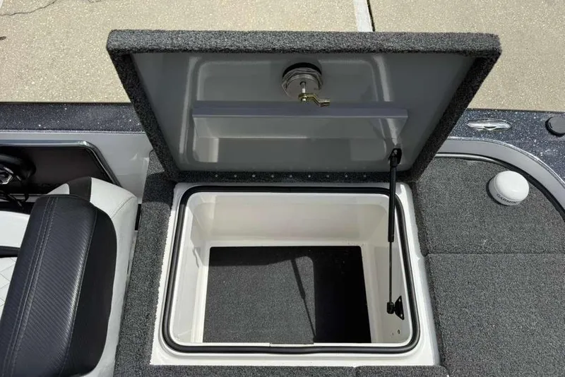 Slide: The Image of Open storage compartment in 2025 Caymas CX 20 PRO boat, featuring carpeted interior. - 39