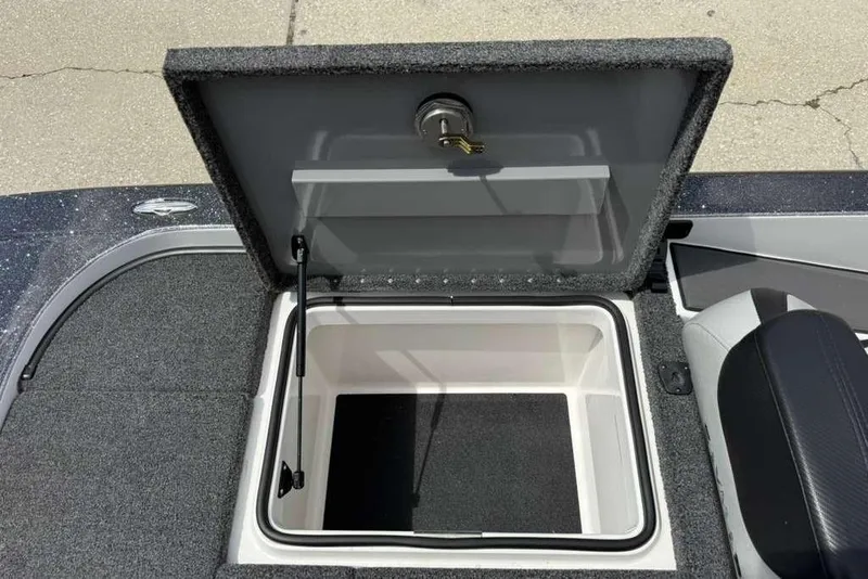 Slide: The Image of Open storage compartment in 2025 Caymas CX 20 PRO boat, featuring carpeted interior. - 40