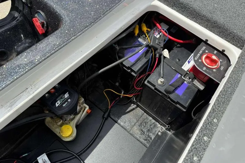 Slide: The Image of Battery compartment of 2025 Caymas CX 20 PRO boat, featuring wiring and power controls. - 43