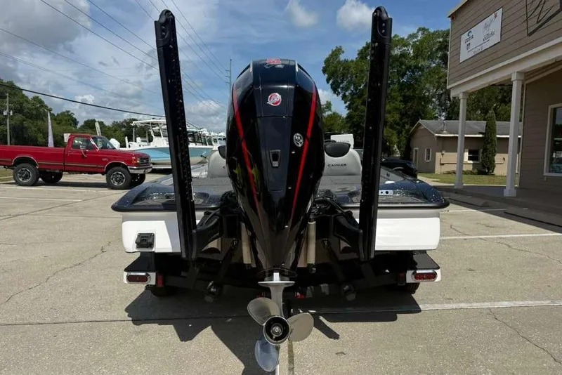 Slide: The Image of 2025 Caymas CX 20 PRO boat rear view with powerful outboard motor in parking lot. - 8
