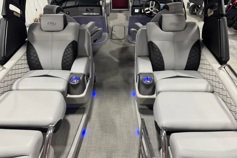 Slide: The Image of Luxurious interior of 2021 Manitou 25 LX boat with plush seating and ambient lighting. - 10