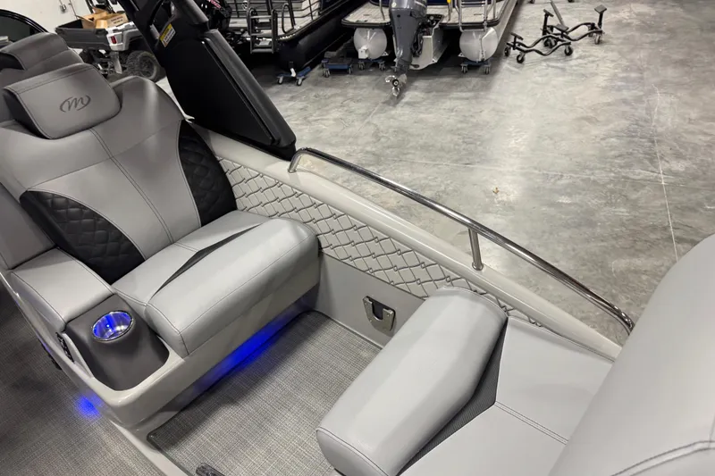 Slide: The Image of Luxurious interior of 2021 Manitou 25 LX boat with plush seating and ambient lighting. - 11