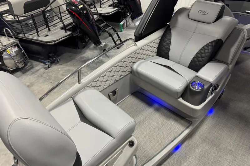 Slide: The Image of 2021 Manitou 25 LX boat interior with luxurious seating and ambient lighting. - 12