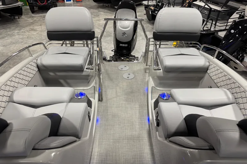 Slide: The Image of 2021 Manitou 25 LX boat interior with luxurious seating and modern design. - 13