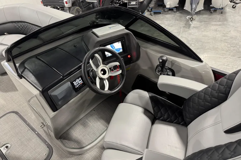 Slide: The Image of Interior view of 2021 Manitou 25 LX boat cockpit with steering wheel and control panel. - 16