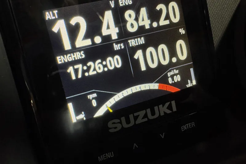 Slide: The Image of Dashboard display of a 2021 Manitou 25 LX boat with Suzuki engine metrics. - 17