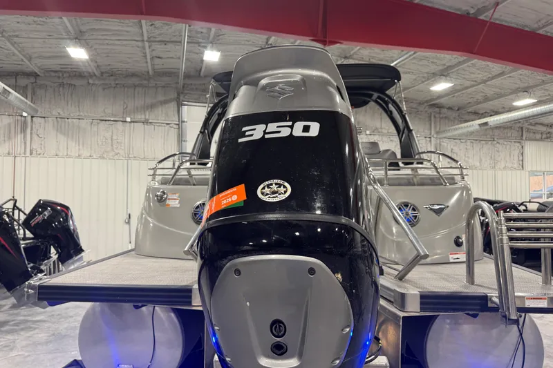 Slide: The Image of 2021 Manitou 25 LX boat with 350 horsepower engine in showroom. - 6