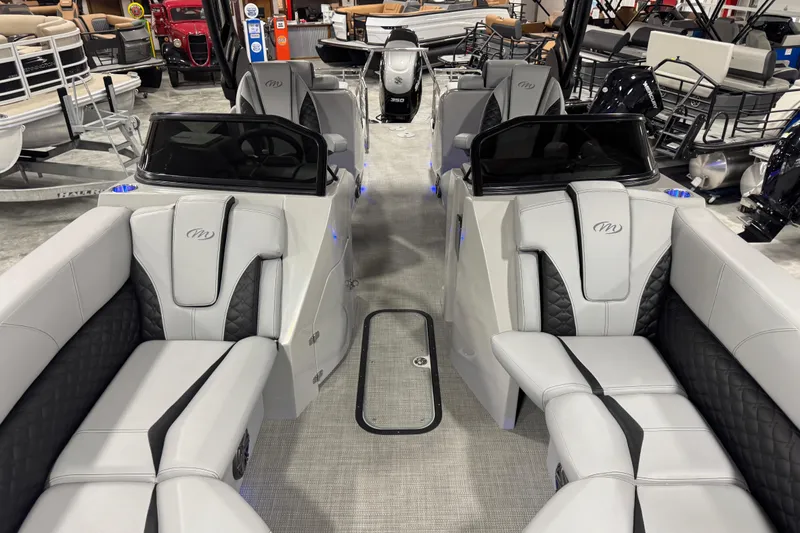 Slide: The Image of 2021 Manitou 25 LX pontoon boat interior with luxurious seating and modern design. - 7
