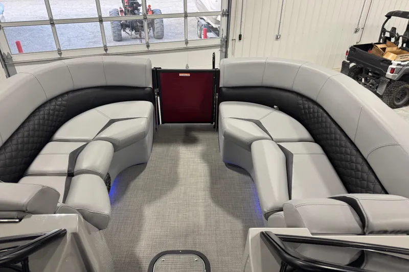 Slide: The Image of Luxurious interior of 2021 Manitou 25 LX pontoon boat with plush seating and modern design. - 8