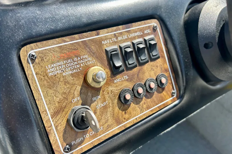 Slide: The Image of Control panel of a 2004 Starcraft D-Star 160 DLX SC boat with switches and ignition. - 17