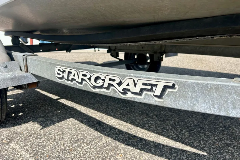 Slide: The Image of Trailer of 2004 Starcraft D-Star 160 DLX SC boat on pavement. - 6