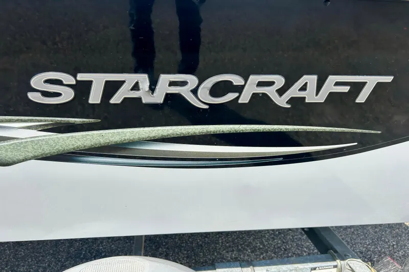 Slide: The Image of 2004 Starcraft D-Star 160 DLX SC logo on black surface. - 8