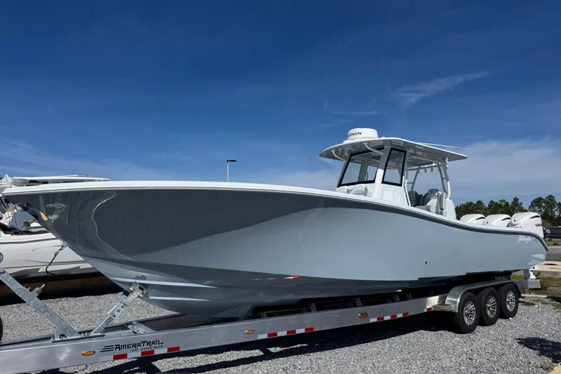 The Image of 2026 Yellowfin 36 Offshore boat on trailer under clear blue sky. - 1