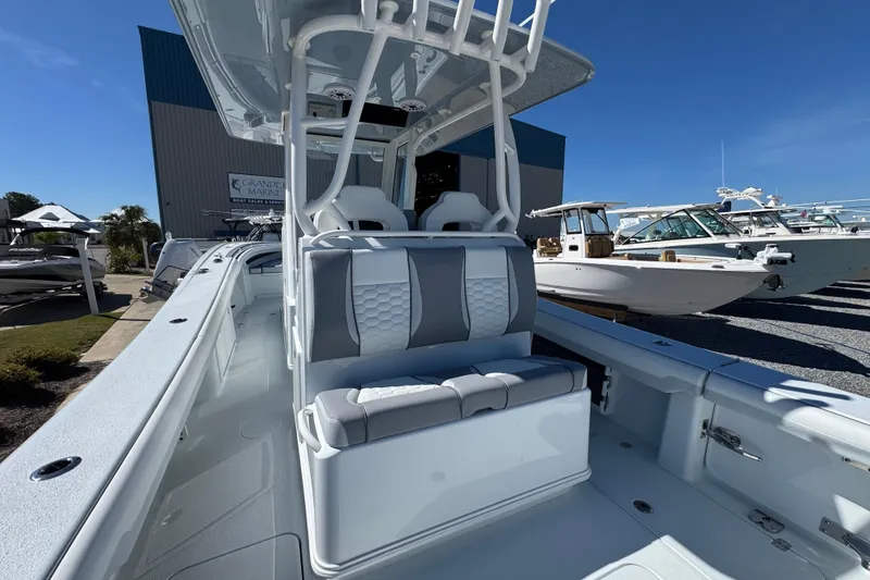 Slide: The Image of 2026 Yellowfin 36 Offshore boat with sleek seating and modern design at a marina. - 12