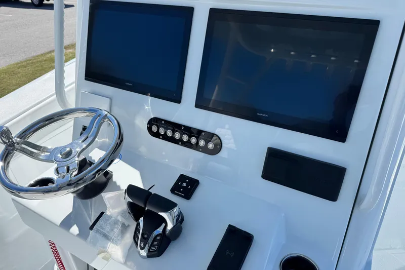 Slide: The Image of 2026 Yellowfin 36 Offshore boat dashboard with dual Garmin displays and steering wheel. - 19
